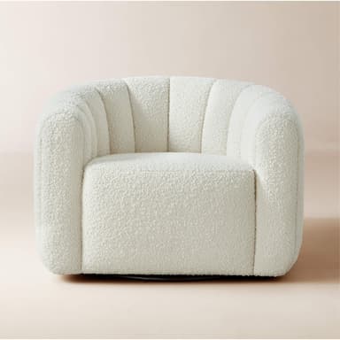 A cream-colored, rounded ottoman with vertical channel tufting across its exterior. The upholstery has a textured, boucle-like finish. The base appears to be dark and low-profile, supporting the cylindrical body of the ottoman. — 3D model
