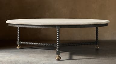 An oval coffee table featuring a light-colored, rough-hewn stone tabletop. The base consists of a dark, textured metal frame supporting four barley-twist style legs, which are interconnected by a stretcher of similar twisted design. Each leg terminates in a spherical brass foot. The overall aesthetic is rustic and traditional. — 3D model