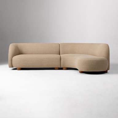 A modular, curved sectional sofa with a low profile and rounded edges. The sofa is upholstered in a textured beige fabric and supported by short, cylindrical wooden legs. — 3D model