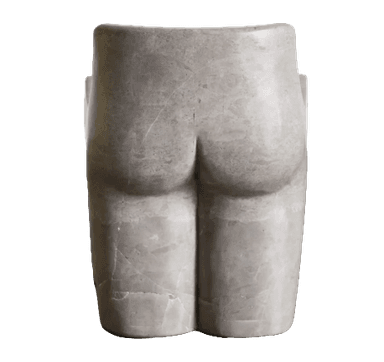 A monolithic accent chair crafted from a single block of natural travertine stone, featuring an organic, sculptural form with a distinctly contoured backrest and seat. The stone exhibits natural porosity and a light beige hue. — 3D model
