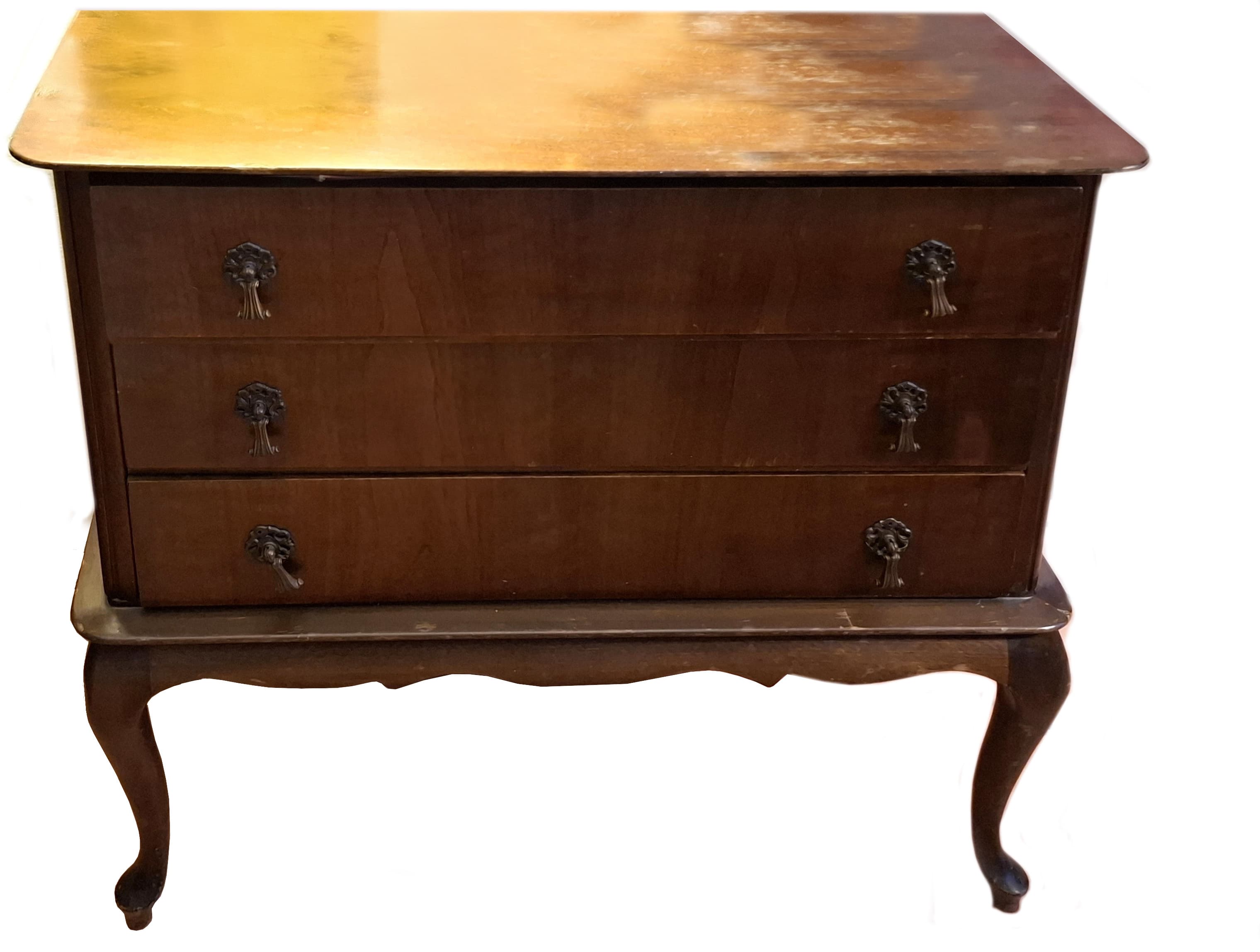 A three-drawer chest of drawers with a dark wood finish and ornate metal drawer pulls. The piece features curved legs and a tiered base. The top surface shows signs of wear and discoloration. — 3D model