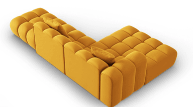 A modular sectional sofa with a rounded, tufted design. The sofa is upholstered in a soft, textured fabric and features a series of evenly spaced vertical channels on its seat cushions, backrests, and armrests. Two square throw pillows, matching the sofa's upholstery, are placed on the sofa. The configuration suggests an L-shaped arrangement, indicating a corner sofa or a multi-piece sectional. — 3D model