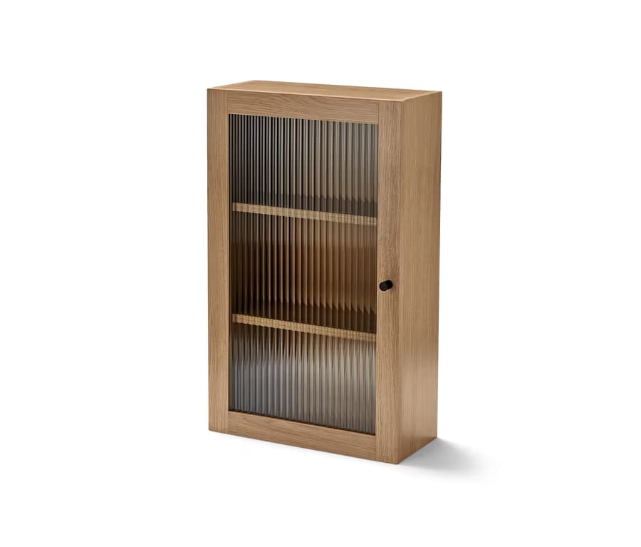 A narrow wooden cabinet with a single fluted glass door and two visible internal shelves. The cabinet is constructed from light-colored wood and features a minimalist design with a small black knob as the door handle. The fluted glass provides a textured, partially obscuring view of the interior. — 3D model
