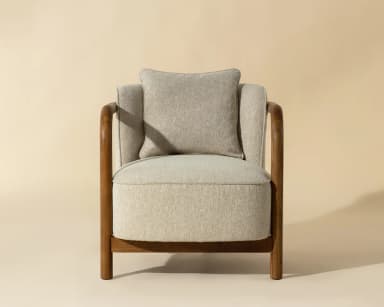 A single armchair with a wooden frame and upholstered seat, back, and armrests. It features a square-shaped seat cushion and a separate lumbar pillow. The wooden frame is visible as curved arms and legs, forming a distinct silhouette. — 3D model