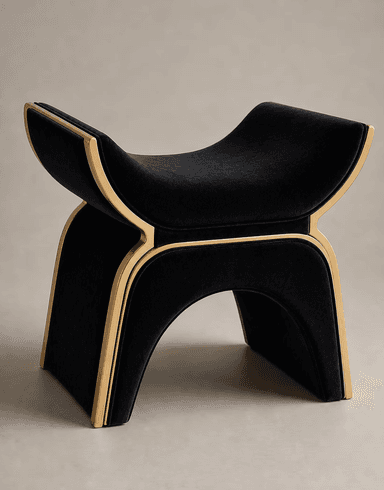 A modern sculptural stool upholstered in black velvet with a matte gold metal frame. The design features continuous, flowing curves forming both the seat and the base, giving it a distinctive and elegant silhouette. It is a backless, single-person seating unit. — 3D model
