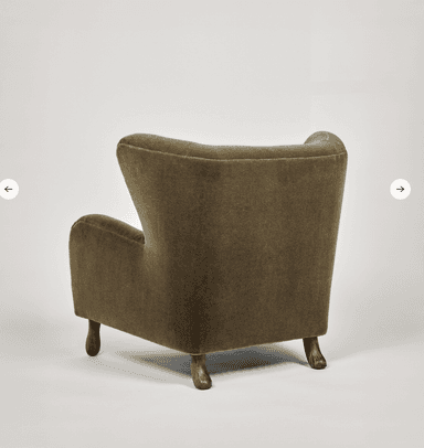 A high-backed upholstered lounge chair in a deep olive green velvet-like fabric, featuring button tufting on the backrest, rounded armrests, and short, splayed dark wood legs. — 3D model