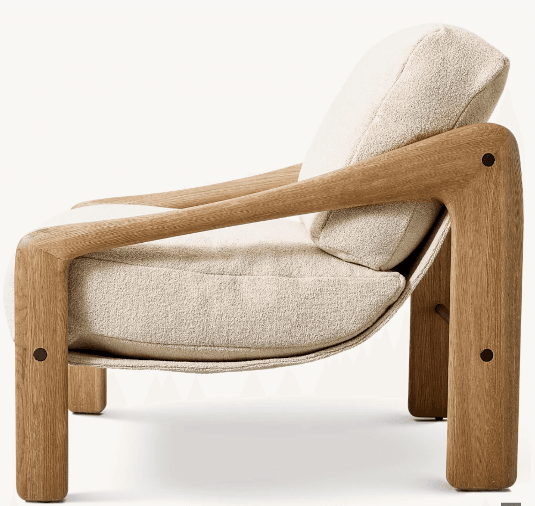 A contemporary lounge chair featuring a prominent, sculptural wooden frame with integrated armrests, supporting a deep-seated, upholstered cushion system. The frame is crafted from light-toned wood with a visible grain, possibly oak or ash, and has rounded edges. The seat and backrest are composed of thick, plush cushions upholstered in a cream or off-white bouclé fabric, providing a soft, textured contrast to the smooth wood. The design emphasizes comfort and a minimalist yet inviting aesthetic. — 3D model