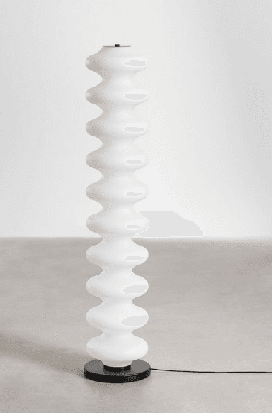A tall, slender contemporary floor lamp featuring a column of stacked, frosted ovoid segments. The segments diffuse light evenly, creating a soft ambient glow. The lamp is supported by a flat, circular black base, and topped with a small, flat black cap, maintaining a minimalist aesthetic. — 3D model