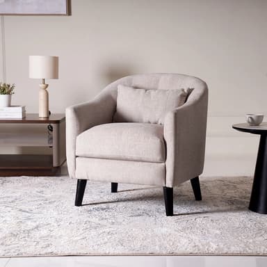 A contemporary upholstered club chair featuring a rounded back, integrated armrests, a single seat cushion, and dark tapered legs. It includes a matching throw pillow for added comfort. — 3D model