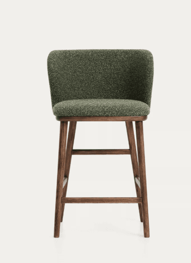 A bar stool with a curved, upholstered backrest and seat, supported by four wooden legs connected by a footrest. The stool features a textured, greenish-brown fabric for the seating and backrest, and a dark wood finish for the frame. — 3D model