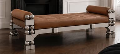 A striking postmodern daybed featuring a polished chrome frame with intricate geometric and spherical details, paired with a tufted, rich brown upholstered cushion and cylindrical bolster pillows at each end. The metallic frame consists of rectangular and triangular elements adorned with stacked chrome spheres, creating a bold and reflective aesthetic. — 3D model