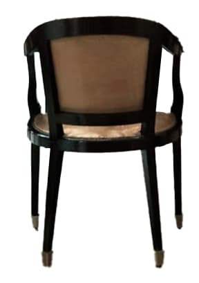 A dark-framed armchair with a light-colored upholstered seat and back. The armchair features curved arms and legs with metallic accents at the base. — 3D model