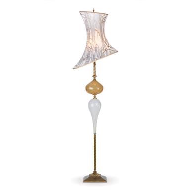 A tall, ornate floor lamp featuring a distressed brass finish base and stem, supporting a multi-part body composed of sculpted glass elements in amber and white, topped with an asymmetric, flared fabric shade patterned with delicate branch-like motifs. The lamp has a vintage, decorative aesthetic. — 3D model