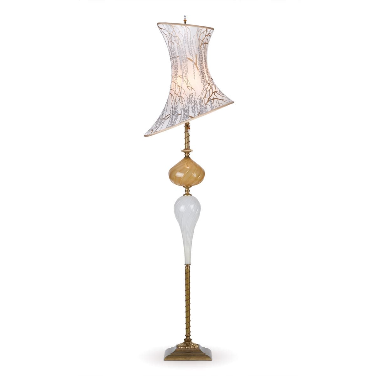 A tall, ornate floor lamp featuring a distressed brass finish base and stem, supporting a multi-part body composed of sculpted glass elements in amber and white, topped with an asymmetric, flared fabric shade patterned with delicate branch-like motifs. The lamp has a vintage, decorative aesthetic. — 3D model