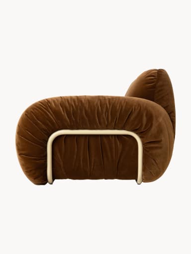 A brown velvet armchair with a rounded, overstuffed silhouette and a visible cream-colored tubular metal frame. The upholstery features deep tufting and ruching, creating a plush and voluminous appearance. The frame provides structural support and a distinctive visual element. — 3D model