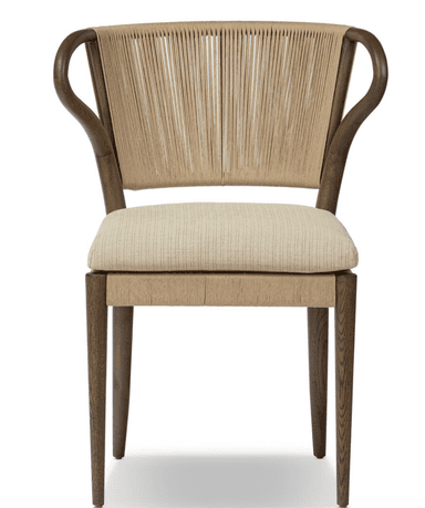 A modern armchair with a curved wooden frame and a woven backrest. The seat is upholstered with a neutral-colored fabric. The armrests are also formed from curved wooden elements, seamlessly integrating into the backrest structure. The woven back features vertical cords creating a textured surface. A tie closure secures the seat cushion. — 3D model