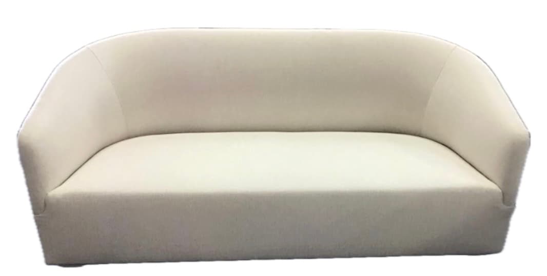 A contemporary loveseat upholstered in cream-colored fabric, featuring a seamless design with integrated curved arms and backrest, and a fixed seat cushion. — 3D model