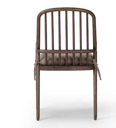 A wooden armchair with a curved backrest composed of vertical spindles. It features rounded armrests and a cushioned seat. The frame is constructed from dark wood, and the cushion is upholstered in a neutral-toned fabric. — 3D model