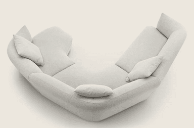 A sectional sofa with a curved, modular design, upholstered in a light-colored, textured fabric. The sofa features multiple seating sections and detached cushions for comfort. It is arranged in a semi-circular configuration, suggesting it is designed for a corner or open-plan space. — 3D model