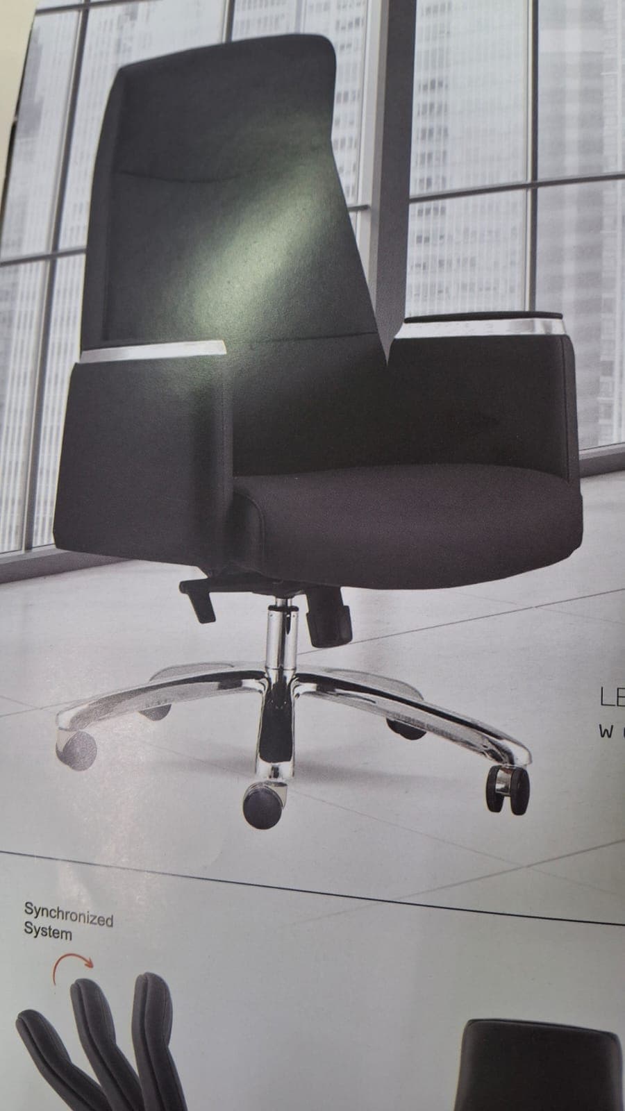 A high-back executive office chair upholstered in black synthetic leather, featuring padded armrests with chrome accents. It has a polished chrome five-star swivel base equipped with five black casters for mobility. The chair includes visible levers for height adjustment and recline control, typical of an office task chair. — 3D model