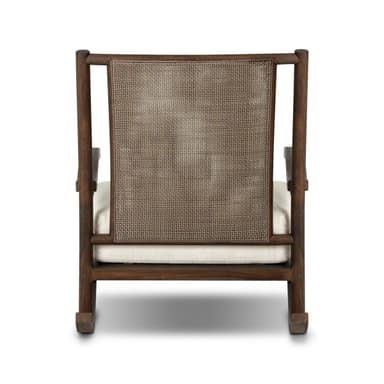 A rocking chair with a dark wood frame and woven cane back. The seat is upholstered in a white fabric. The chair has a classic rocking chair design with curved runners. — 3D model