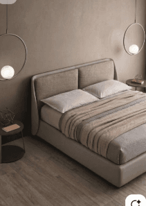A modern platform bed with a fully upholstered frame and a distinct two-panel headboard. The bed is presented with light-colored bedding, including pillows and a blanket. — 3D model