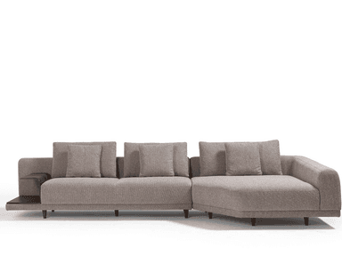 A modern sectional sofa with a chaise lounge on the right side. It features a low profile with upholstered cushions and a textured fabric. An integrated dark wood side table with a shelf is attached to the left end of the sofa. — 3D model