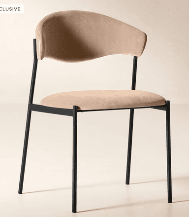 A modern dining chair featuring a black metal frame and light beige upholstered seat and a distinctively curved backrest. — 3D model