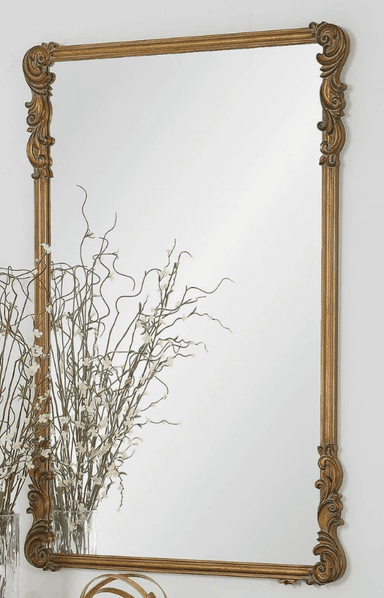 A rectangular mirror with a decorative, ornate frame. The frame has a golden finish and features carved scrollwork and fluting along its sides. The corners are adorned with elaborate acanthus leaf-like carvings. The mirror surface is clear and reflective. — 3D model