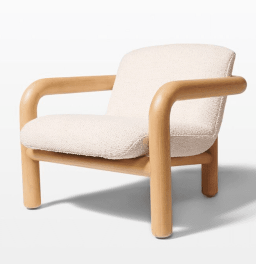 A modern armchair featuring a solid wood frame with rounded edges and a boucle upholstered seat and backrest. The armrests are integrated into the frame, creating a continuous, curved line from the legs to the top of the armrests. The upholstery has a textured, looped appearance. — 3D model