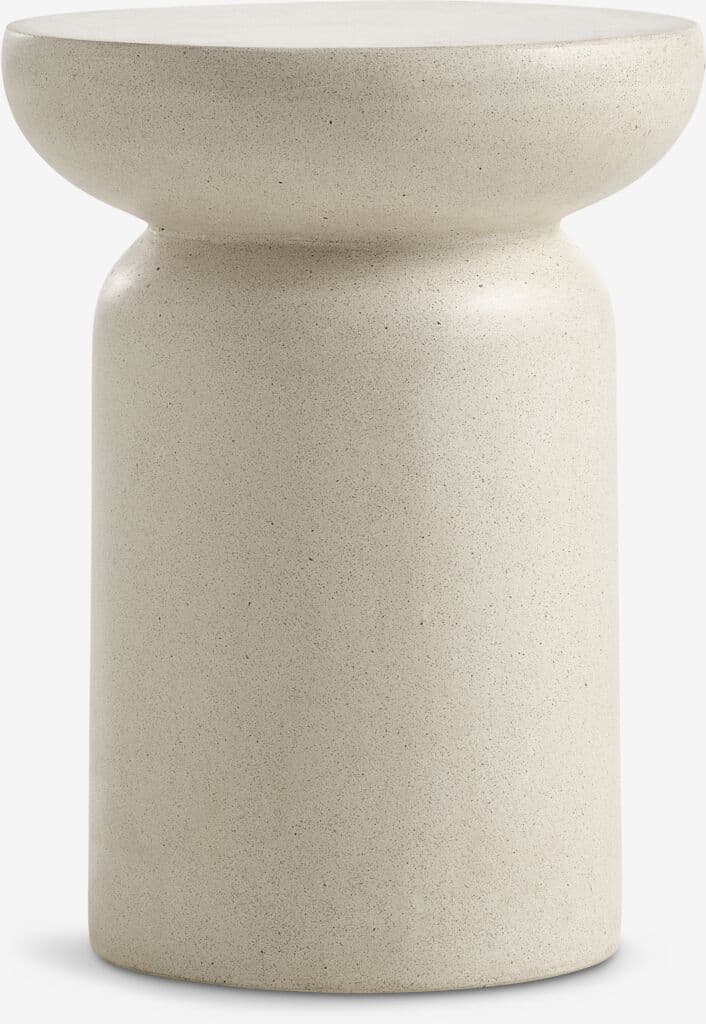 A cylindrical, hourglass-shaped furniture piece in a light speckled finish, resembling cement or terrazzo. It features a broad, flat top surface, a tapered central section, and a wider cylindrical base. — 3D model