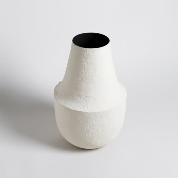 A decorative vase featuring an inverted teardrop or gourd-like silhouette, with a narrow, tapered neck and a wider, rounded base. The exterior is finished with a matte, textured white coating, resembling a rough plaster or paper-mache effect. The interior of the neck shows a contrasting smooth black surface. — 3D model
