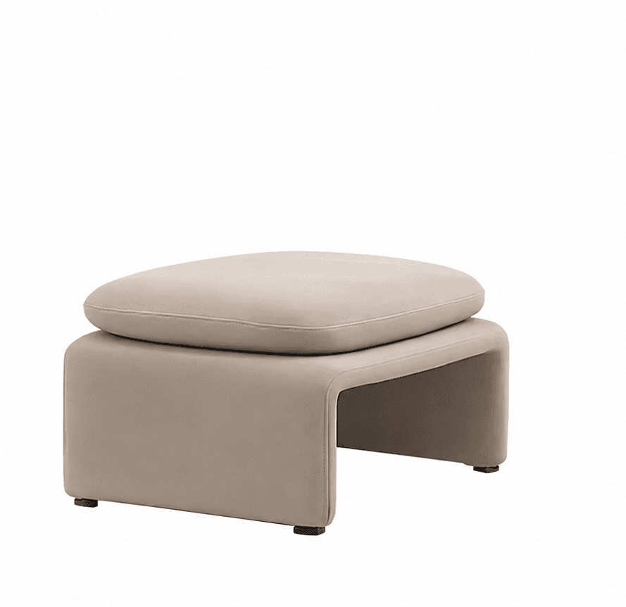 A modern upholstered ottoman featuring a distinctive U-shaped base and a separate, plush top cushion. The entire piece is covered in a smooth, light beige or taupe material, emphasizing soft lines and a minimalist aesthetic. Small, dark feet are visible at the base. — 3D model