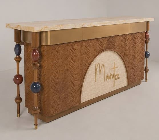 A distinctive postmodern bar cabinet featuring a rectangular marble top, a brass accent band, and a textured wooden facade. The front panel is carved with a wave-like pattern, and an arched inset upholstered in light fabric adds a contrasting element. The cabinet is supported by four ornate turned wooden legs, each adorned with colorful spherical accents in red and blue. The overall design suggests a blend of Art Deco and postmodern aesthetics. — 3D model