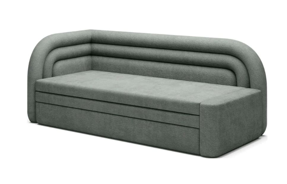A modern upholstered sofa with a rounded corner and a channel-tufted backrest. The sofa features a low profile and a textured fabric upholstery. The armrest on the right is integrated into the main body, creating a cohesive, block-like form. The base of the sofa is also upholstered and appears to have horizontal segmented lines. — 3D model