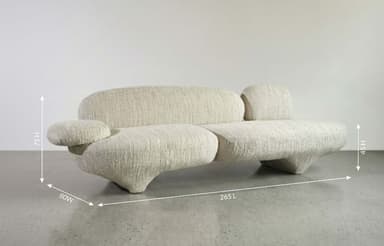 A contemporary two-seater loveseat featuring a highly organic, rounded, and sinuous form. Upholstered in a light, textured fabric, possibly bouclé, with integrated, curved armrests and backrests. The design is fluid, with no sharp edges, and rests on a low, subtly integrated upholstered base. — 3D model