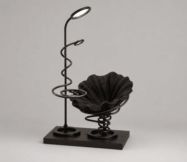 A modern accent chair featuring a dark, ruffled fabric seat supported by a prominent coiled spring mechanism. The chair is integrated with a floor lamp that has two oval LED light fixtures and a decorative spiral metal accent on its stand. Both the chair and the lamp are mounted on a dark wood base. — 3D model