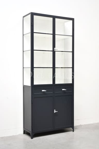 A tall, black industrial-style cabinet featuring an upper section with two frosted glass-paned doors and internal shelves, and a lower section with two small drawers and two solid, opaque doors. It is constructed from metal with a matte finish and stands on four short, angled feet. Silver-toned hardware is present on the doors and drawers. — 3D model
