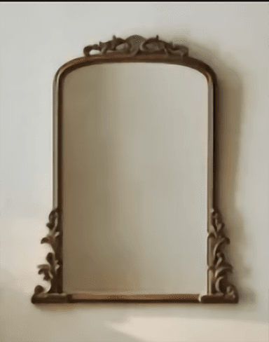 A freestanding cheval mirror featuring an arched top and an elaborately carved dark brown wooden frame. The frame exhibits intricate scrollwork and decorative motifs along its top curve and base, suggesting a traditional or baroque-inspired design. The mirror glass is clear, offering a full-length reflection. — 3D model