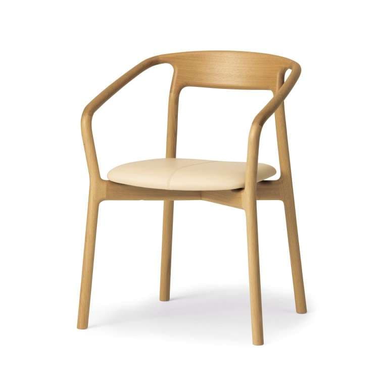 A contemporary armchair with a light wood frame and a cushioned seat. The frame has a minimalist design with curved armrests that flow into the backrest, supported by four slender legs. The seat is upholstered in a light-colored material, likely leather or fabric. — 3D model