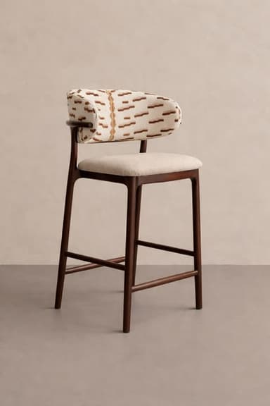 A bar stool featuring a dark wood frame with a light-colored upholstered seat and a distinctively patterned upholstered backrest. The backrest is curved and partially wraps around, offering slight arm support. The legs are slender, joined by footrests and cross-bracing for stability. — 3D model
