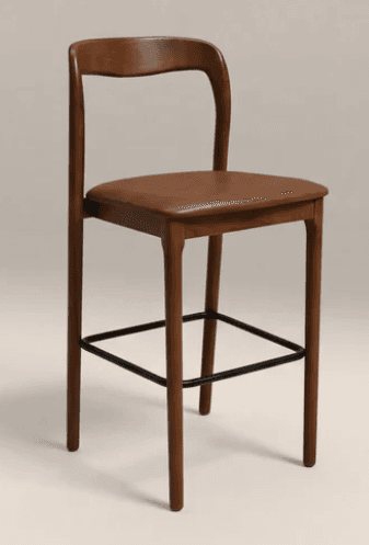 A bar stool featuring a solid wood frame with a warm brown finish, a gently curved backrest, and a rectangular padded seat upholstered in brown material. It has four tapered legs connected by a black metal footrest. — 3D model