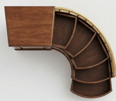 An exquisite Art Deco style bar cabinet featuring a distinctive curved form and rotating functionality. It is constructed from dark wood, likely walnut, with a rectangular top surface and interior trays adorned with a finely crafted herringbone veneer pattern. The curved exterior edge is elegantly finished with a polished brass rail. The cabinet's unique design incorporates multiple fan-shaped, segmented trays that appear to slide or rotate outwards, offering organized storage for bar essentials. — 3D model