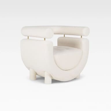 A contemporary cream-colored accent chair featuring a distinctive U-shaped upholstered body with a separate, cylindrical backrest/armrest element supported by thin brass rods. The chair is upholstered in a soft boucle fabric and stands on short, cylindrical upholstered legs. — 3D model