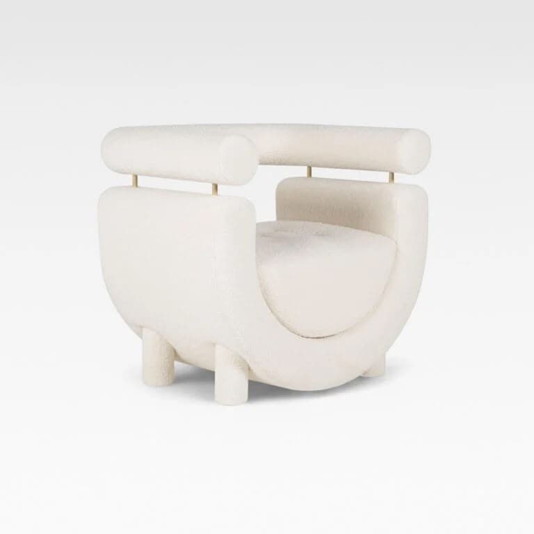 A contemporary cream-colored accent chair featuring a distinctive U-shaped upholstered body with a separate, cylindrical backrest/armrest element supported by thin brass rods. The chair is upholstered in a soft boucle fabric and stands on short, cylindrical upholstered legs. — 3D model