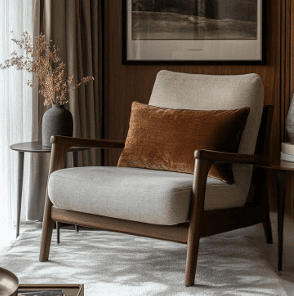 A modern armchair featuring a dark wooden frame and light-colored upholstered cushions, accented with a contrasting rust-colored rectangular throw pillow. — 3D model