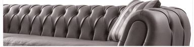 A contemporary chaise lounge featuring deep button tufting on its curved ends and pleated detailing along its side, upholstered in a light taupe leather. — 3D model