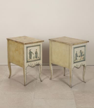 A pair of matching nightstands with two drawers each. The front panels of the drawers and the lower skirt are adorned with hand-painted blue and white scenic details, featuring boats and architectural elements. The nightstands have a distressed cream-colored finish and are supported by four cabriole legs. The top surface appears to be a different material, possibly a veneer or stone. — 3D model