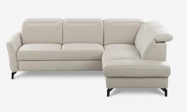 An L-shaped sectional sofa upholstered in a light beige or off-white material, likely leather or faux leather. It features a three-seater section connected to a right-hand facing chaise lounge. The backrests have distinctive padded headrest sections, and the sofa rests on sleek, minimalist black metal legs. — 3D model
