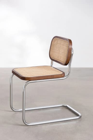 A modern cantilever chair with a tubular chrome frame and a seat and backrest made of wood with cane webbing. The chair has a distinct industrial design aesthetic. — 3D model